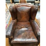 A VINTAGE BROWN LEATHER CLUB ARMCHAIR BUN FEET