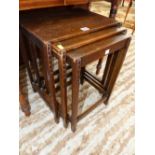 A NEST OF THREE ARTS AND CRAFTS OAK TABLES TOGETHER WITH A MAHOGANY BEDSIDE CUPBOARD, THE SHAPED