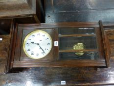 A VINTAGE GLAZED STAINED WOOD WALL CLOCK CHIMING ON RODS, THE DIAL WITH ARABIC NUMERALS. H 69cms.