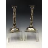 A PAIR OF SILVER CANDLESTICKS BY D AND M DAVIS, LONDON 1926, THE COLUMNS WITH SPIRAL BANDS OF ACORNS