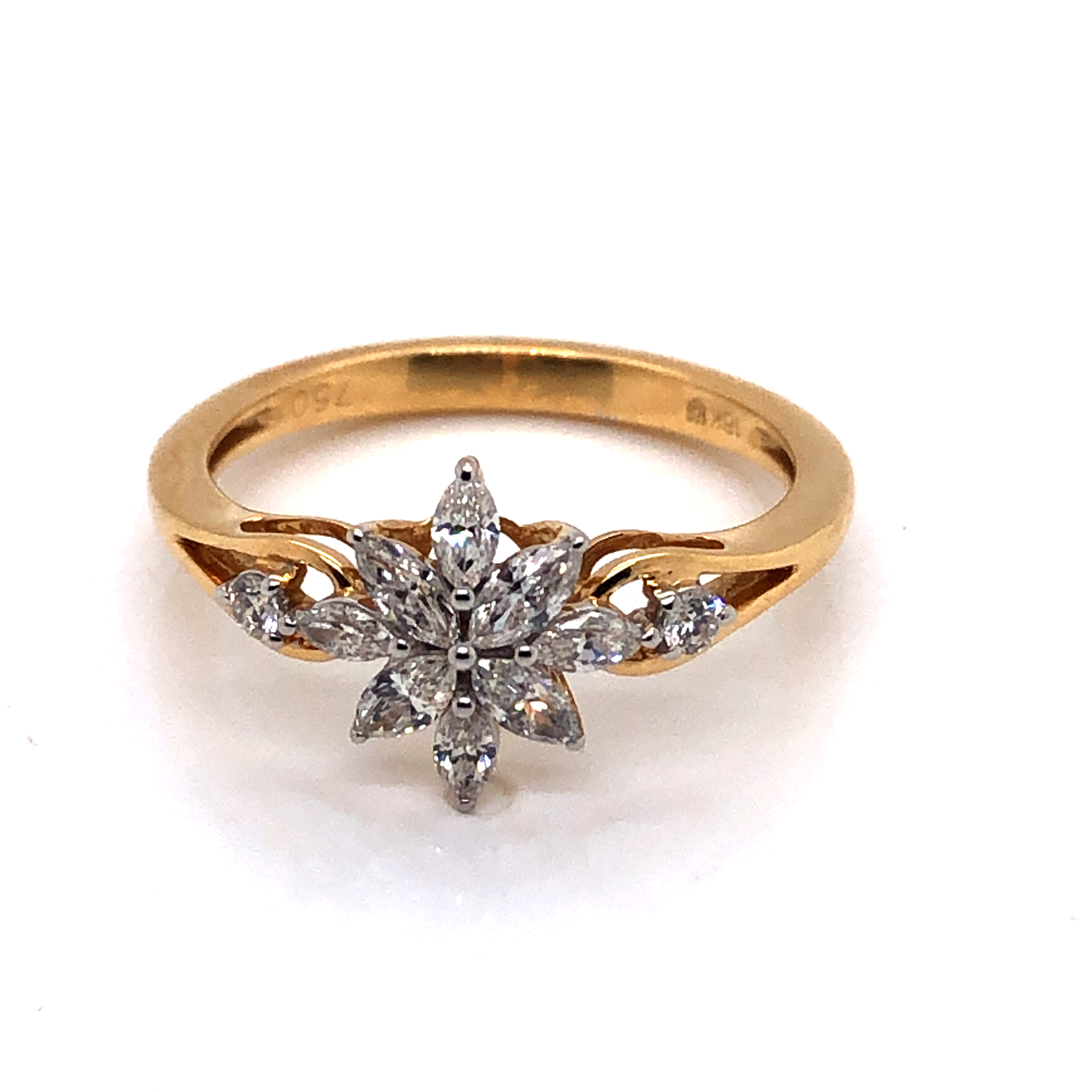 A DIAMOND FLORAL CLUSTER RING. THE FLORAL DESIGN CONSISTING OF EIGHT MARQUISE CUT DIAMONDS WITH