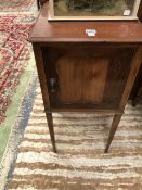 AN EDWARDIAN MAHOGANY BEDSIDE CUPBOARD ON TAPERING SQUARE SECTION LEGS