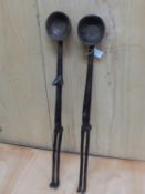 A PAIR OF LATE 19th C. SENUFO WOODEN LADLES, THE ELONGATED HANDLES IN THE FORMS OF NAKED MALE AND