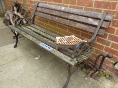 A GARDEN BENCH WITH PAINTED IRON ENDS