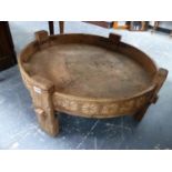 A CARVED WOOD SHALLOW FOUR FOOTED BOWL WITH A DRAINAGE HOLE TO ONE SIDE, POSSIBLY SCANDINAVIAN AND