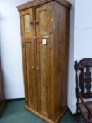 A RUSTIC PINE NARROW FARM KITCHEN CUPBOARD, FOUR PANELLED DOORS. H 226. W 89. D 56cms