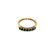 A 9ct HALLMARKED GOLD SEVEN STONE EMERALD HALF ETERNITY RING. FINGER SIZE N. WEIGHT 1.82grms.