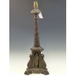 A BRONZE COLUMNAR TABLE LAMP ENTWINED BY FLOWERING VINE ABOVE THREE CLASSICAL FIGURES IN NICHES