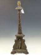 A BRONZE COLUMNAR TABLE LAMP ENTWINED BY FLOWERING VINE ABOVE THREE CLASSICAL FIGURES IN NICHES