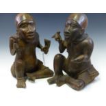 A PAIR OF MID 19th C. YORUBA BRONZE TWINS, BOTH SEATED SIMILARLY ON THE GROUND WEARING SKULL CAPS