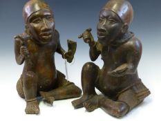 A PAIR OF MID 19th C. YORUBA BRONZE TWINS, BOTH SEATED SIMILARLY ON THE GROUND WEARING SKULL CAPS