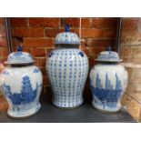 A PAIR OF ORIENTAL BLUE AND WHITE PAGODA DECORATED COVERED VASES SIX CHARACTER MARK H 39cms TOGETHER