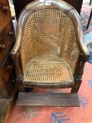 A 19th C. CANED MAHOGANY CHILDS CHAIR WITH A FOOT REST ADJUSTABLE ON THE FRONT LEGS, THE TOP RAIL