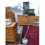 A GIANT CHROME FLOOR STANDING ANGLE POISE LAMP TOGETHER WITH A ALUMINIUM CEILING SHADE.