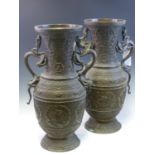 A PAIR OF CHINESE BRONZE BALUSTER VASES, THE DRAGON HANDLES COMPLEMENTING DRAGON ROUNDELS IN BANDS