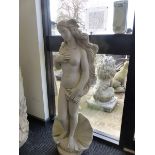 A COMPOSITE GARDEN FIGURE OF A LADY WITH LONG HAIR WITH A SEA SHELL BASE DECORATION.