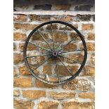 A SMALL CAST IRON WHEEL DIAMETER 63cms. VIEWING FOR THIS ITEM IS BY APPOINTMENT ONLY, AND IS NOT
