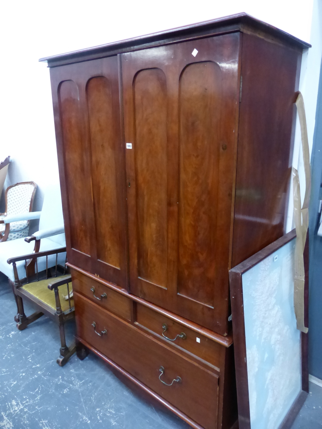 A 19th C. MAHOGANY LINEN PRESS, THE TOP WITH DOORS EACH WITH TWO ROUNDED TOPPED PANELS AND ENCLOSING