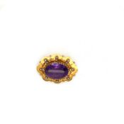 AN ANTIQUE AMETHYST AND SEED PEARL PANEL BROOCH. THE OVAL AMETHYST SURROUNDED BY A SUN BURST OF