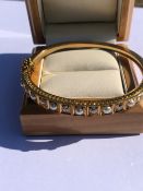 AN ANTIQUE DIAMOND AND PEARL GRADUATED HINGED BANGLE, COMPLETE WITH ADDED SAFETY CHAIN. UNHALLMARKED