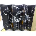 AN ORIENTAL MOTHER OF PEARL INLAID BLACK LACQUER SIX PANEL FLOOR SCREEN. EACH PANEL 182 x 40cms