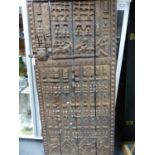 A LATE 19th C. DOGON MAHOGANY GRANARY DOOR CARVED IN RELIEF WITH BANDS OF STYLISED FIGURES RIDING