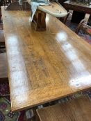 AN EARLY 20th C. OAK TRESTLE TABLE ON CUP AND COVER LEGS AND SPLAY FEET. W 183 x D 76.5 x H 74cms.