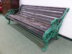 A LARGE ANTIQUE GARDEN BENCH WITH PAINTED CAST IRON ENDS IN THE FORM OF DRAGONS. H 77 x W 190 x D
