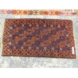 AN ANTIQUE BELOUCH RUG 186 x 102 cms