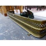 A VICTORIAN BRASS FIRE KERB PIERCED WITH TWO BANDS AND ON PAW FEET. W 121cms.