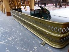 A VICTORIAN BRASS FIRE KERB PIERCED WITH TWO BANDS AND ON PAW FEET. W 121cms.