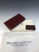 A VINTAGE BURGUNDY LEATHER CARTIER PURSE WITH ORIGINAL BOX, DUST BAG AND CERTIFICATE OF