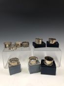 EIGHT VARIOUS HALLMARKED SILVER NAPKIN RINGS TOGETHER WITH A HALL & BARTON BANGALORE NAPKIN RING.