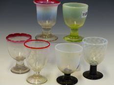 SIX VARIOUSLY COLOURED ANTIQUE GLASS RUMMERS, TO INCLUDE THREE WITH RED RIMS, TWO WITH BLACK FEET