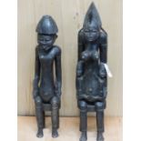 A LATE 19th/EARLY 20th C. SENUFO PAIR OF KING AND QUEEN MAHOGANY FIGURES SEATED ON STOOLS, HE