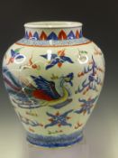 A CHINESE FAMILLE VERTE BALUSTER JAR PAINTED WITH A DRAGON AND A PHOENIX HEAD TO HEAD WITH A FLAMING