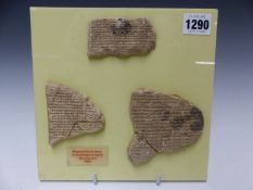 THREE CUNEIFORM PLASTER CASTS FROM THE LIBRARY OF ASHNURBANIPAL, NINEVEH, MOUNTED ON A YELLOW
