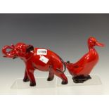 A ROYAL DOULTON FLAMBE ELEPHANT. W 20cms. TOGETHER WITH A DOULTON FLAMBE PINTAIL DUCK. H 15cms.
