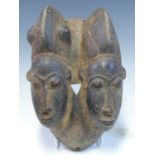 A MAHOGANY MASK, LATE 19th C. ZAIRE, CARVED WITH TWIN HEADS, THE ONE ON THE LEFT WITH BULGES