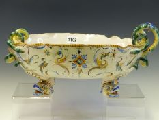 A CANTAGALLI SNAKE HANDLED BOWL, THE EXTERIOR PAINTED WITH GROTESQUES ABOVE FOUR DOLPHIN FEET,