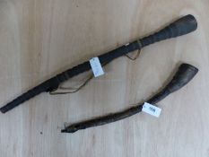 TWO TRIBAL HORNS, EARLY TO MID 20th C., ONE PARTIALLY COVERED IN LEATHER. 56cms. THE OTHER OF WOOD