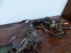 A SADDLE, AN ANTLER HANDLED HUNTING CROP, TWO UMBRELLAS AND LADYS SHOE TREES