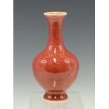 A CHINESE PEACH BLOOM BALUSTER VASE, SIX CHARACTER MARK IN BLUE. H 16.5cms.