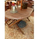 A TEAK FOLDING GARDEN TABLE