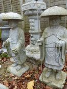 A PAIR OF CARVED GRANITE GARDEN FIGURES OF CHINESE GENTLEMEN IN HATS