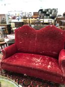 AN ANTIQUE RED VELVET SETTEE SUPPORTED ON MASSIVE MAHOGANY TURNED BUN FEET. W 164cms.