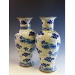 A PAIR OF ORIENTAL BLUE AND WHITE DRAGON DECORATED VASES, SIX CHARACTER MARK H 33cms, TOGETHER