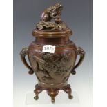 A CHINESE BRONZE INCENSE BURNER AND COVER CAST WITH BIRDS EITHER SIDE OF THE MASK AND TONGUE HANDLES