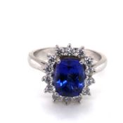 A HALLMARKED PLATINUM TANZANITE AND DIAMOND CLUSTER RING. APPROX SAPPHIRE MEASUREMENTS 9.5 X 7.