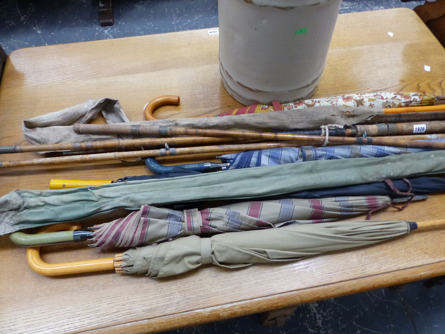 FOUR VARIOUS FISHING RODS TOGETHER WITH FIVE UMBRELLAS